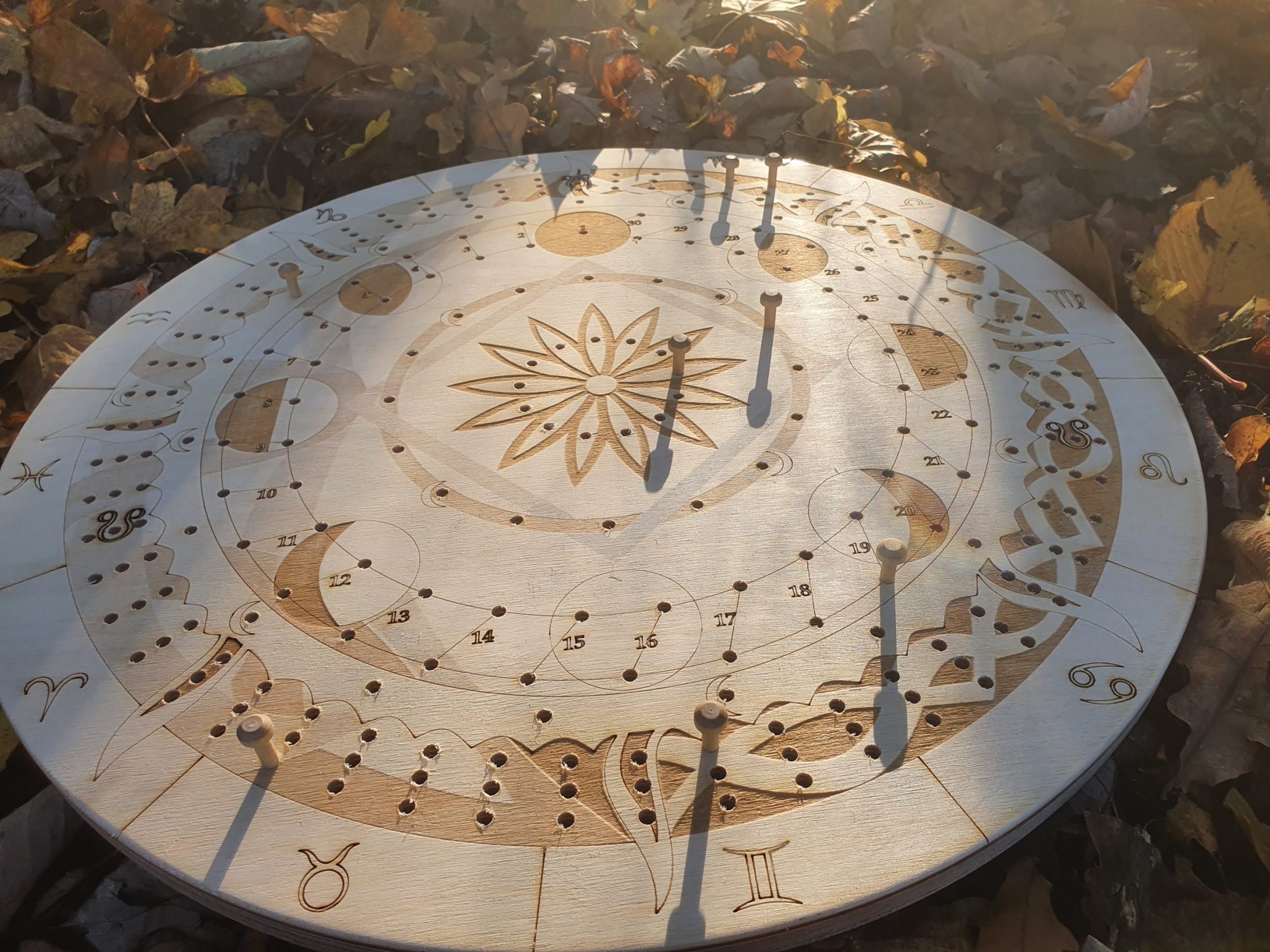 The Druidcraft Calendar out in the sun light among autumn leaves
